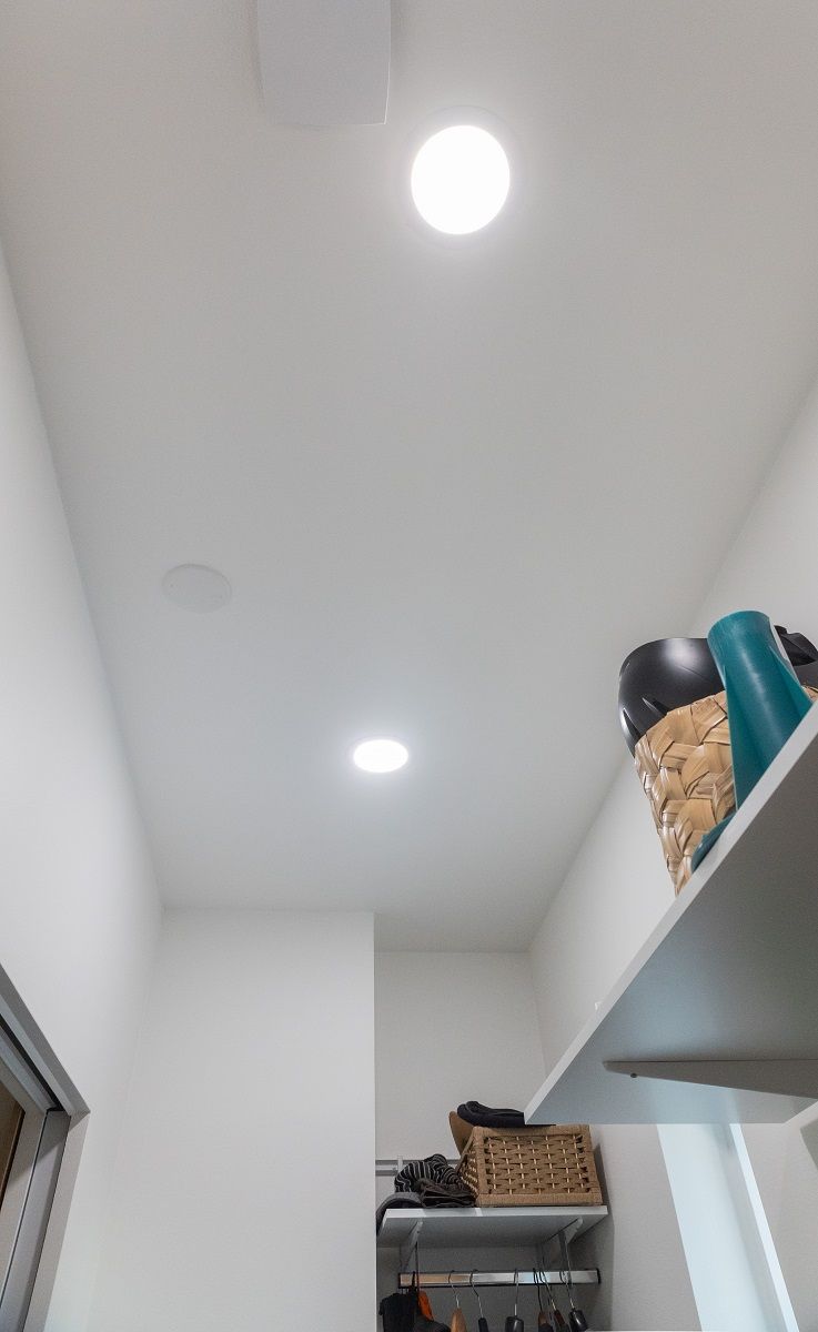 Plafond 200 recessed, circular panel luminaires illuminate the ceiling of the storage area.